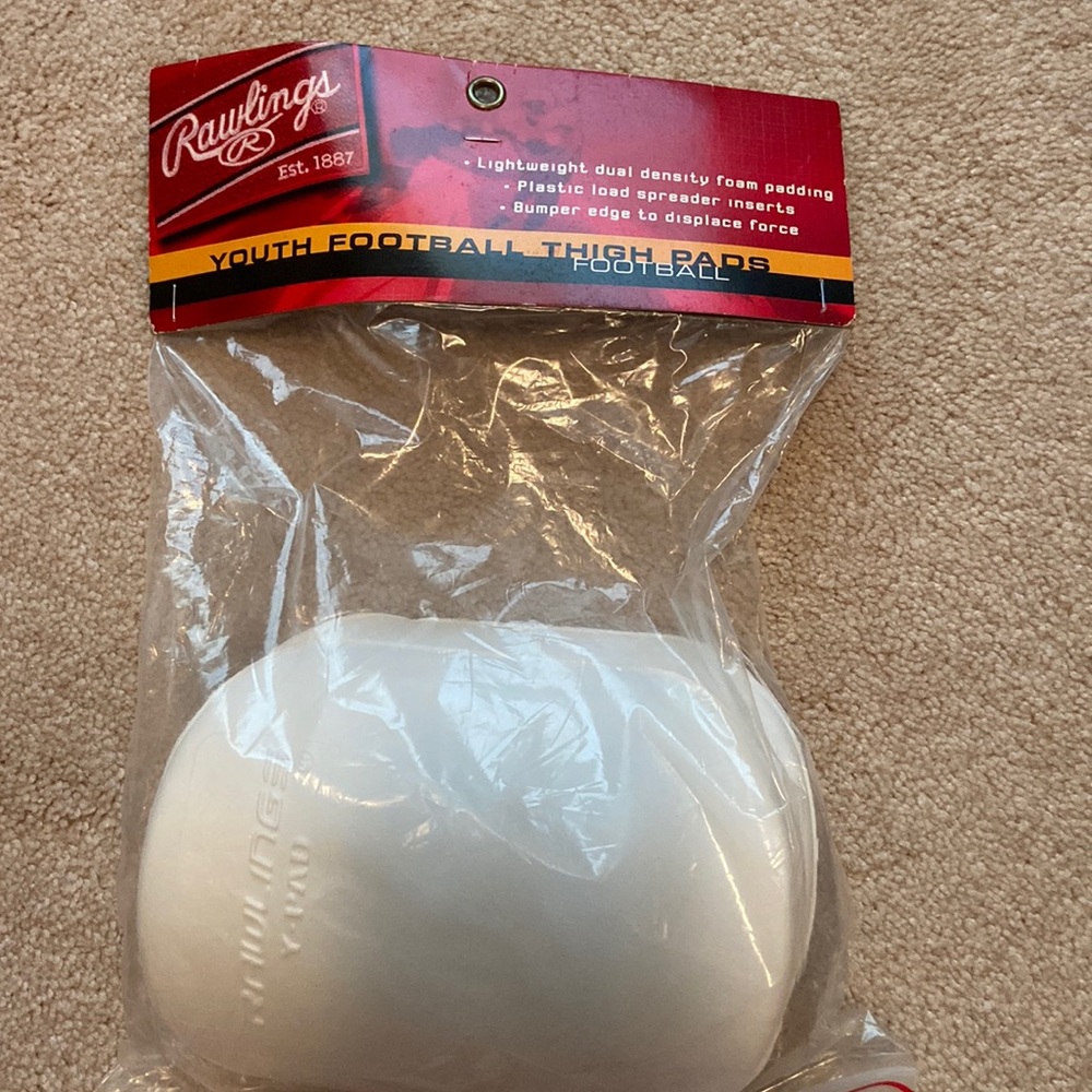 Rawlings youth football thigh pads, new in original bag, never worn